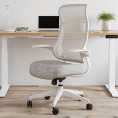 an office chair sitting in front of a desk with a laptop computer on top of it