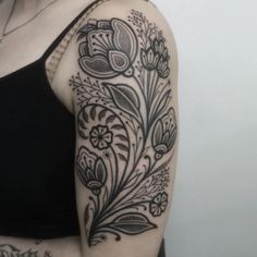 a woman with a black and white tattoo on her arm