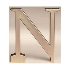 a gold metal letter n on a white background