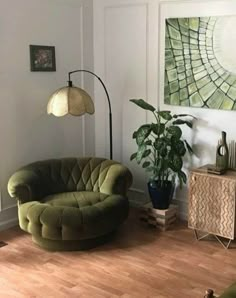 a living room filled with furniture and a painting on the wall