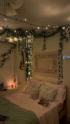 a bedroom decorated with ivy and string lights