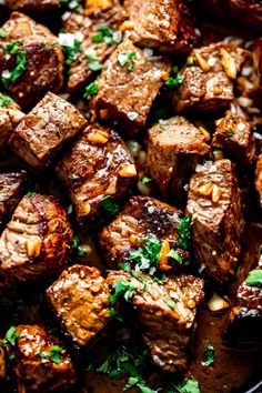 steak bites with parsley on top and the words garlic butter steak bites above it