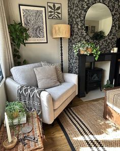 a living room filled with furniture and a mirror on the wall next to a fire place