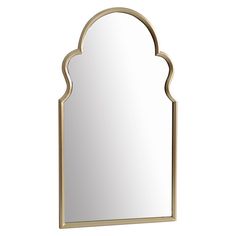 a mirror that is sitting on top of a wall with a gold frame and an arched design