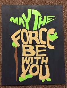 a piece of art that says may the force be with you on black and green