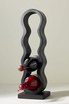 a wine bottle holder that is shaped like a wave and has two bottles in it