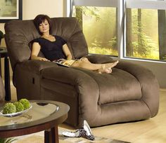 a woman sitting on a recliner in a living room