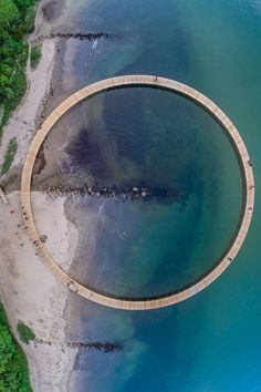 an aerial view of a circular bridge over water