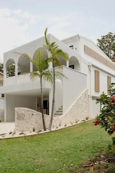 a white house with palm trees in front of it