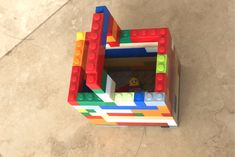 a toy made out of legos sitting on the ground