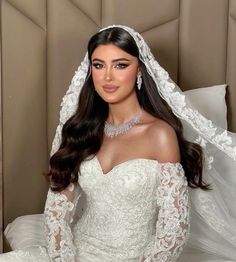 a woman wearing a wedding dress and veil