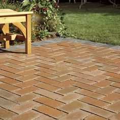 a wooden bench sitting on top of a brick patio