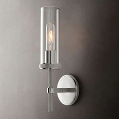 a wall light that is on the side of a wall next to a gray wall