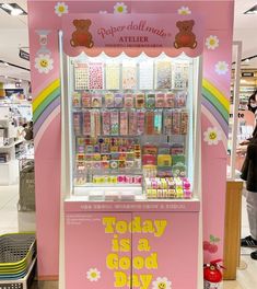 a pink toy vending machine sitting inside of a store