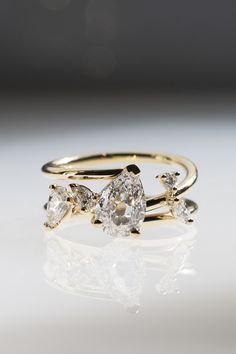 Bespoke engagement ring featuring a pear-shaped diamond center and different marquise and pear diamond accents designed by Grace Lee. Create your own custom engagement ring design using a heirloom stone Antique Engagement Rings Vintage 1920s, Engagement Ring Custom, Unique Ring Designs, Antique Diamond Engagement Rings, Contemporary Engagement Rings, Vintage Inspired Rings