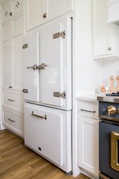 a kitchen with white cabinets and an oven