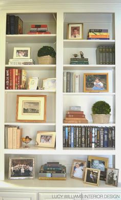 the bookshelf is filled with many different items and pictures on it's shelves