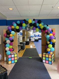 an entrance to a school decorated with balloons and rubik cubes on the floor