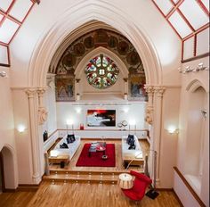 the interior of a church with stained glass windows and wood flooring is shown from above