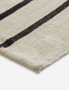 a rug with black and white stripes on the bottom, it is made out of wool