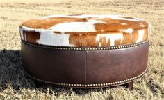 Western ottoman with brown leather and brown and white cowhide - handmade in the USA - Your Western Decor Western Ottoman, Brown And White Hair, Old West Decor, Cowhide Decor, Cowhide Ottoman, Cowhide Furniture, Round Footstool, African Paintings, Rustic Chair