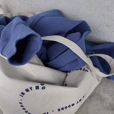 a white and blue bag sitting on the ground