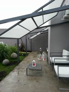 an outdoor patio with chairs, tables and lanterns