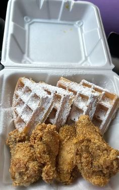 fried chicken and waffles are served in a styrofoam container