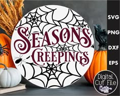 a pumpkin and spider web with the words season's greetings on it next to two