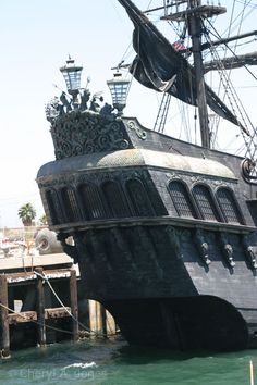 an old pirate ship is docked in the water