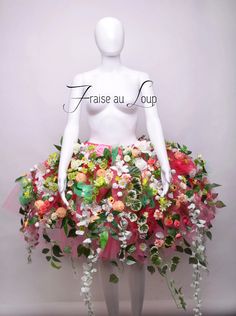 a mannequin wearing a dress made out of flowers