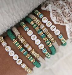 a close up of many different bracelets on a person's arm