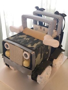 a cake made to look like an army jeep with camouflage print on the front and sides