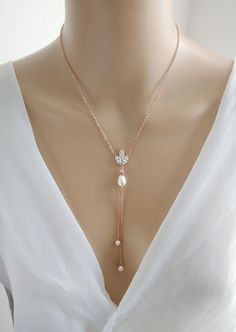 This is an original design by © Isabella Bridal. A simple drop-back necklace in shiny cubic zirconia crystals accented with Swarovski teardrop pearls. Available in - Silver(rhodium), Rose Gold finish - Swarovski Pearl -Cubic Zirconia leaf -Drop length 5 inches Feel free to contact me with any questions! Custom orders are welcome. All orders will ship within 48 hours, except for weekends ALL ORDERS ARE SHIPPED VIA USPS FIRST CLASS WITH TRACKING. Handmade in the USA This item is Made-to-Order and therefore is a final sale. Luxury White Gold Lariat Necklace For Wedding, Jewelry For Bride, Pearl Lariat Necklace, Pearl Lariat, Wedding Jewelry For Bride, Bridal Roses, Back Necklace, Necklace Bridal, Y Necklace