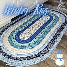 a snowman is standing next to a blue and white quilted table runner with the words winter rug on it