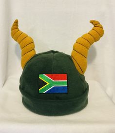 This fabulous South African springbok beanie makes a wonderful addition to your supporters kit. You know you need one in your life! All beanies are hand made from a top quality fleece with plenty of stretch to ensure a perfect fit. With the addition of an embroidered South African flag and of course the iconic springbok horns. There are four sizes available. Small - baby 6-18m Medium- 2-12 years  Medium long - teens and adult female  Large - adult male. African Hat, South African Rugby, Rugby Gifts, South African Flag, African Hats, Small Baby, Costume Hats, Medium Long, Daughter Love