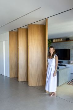 a woman is standing in front of the sliding doors that lead to her living room