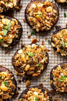 baked stuffed mushrooms with nuts and herbs on a baking sheet