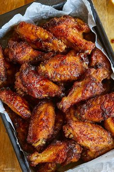 some chicken wings are in a tray on a table