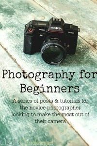 a camera sitting on top of a wooden table with the words photography for beginners