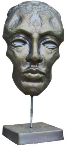 a bronze sculpture of a man's head on a stand