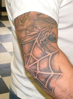 a man with a spider web tattoo on his arm