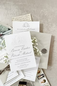 the wedding stationery is laid out on top of each other, including an envelope