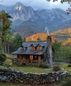 a log cabin in the mountains surrounded by rocks and trees with autumn foliage around it