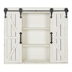 an open white cabinet with black handles and two sliding doors on the front, one door closed