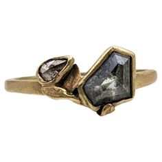 a gold ring with two black diamonds on it