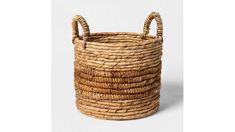 a woven basket with two handles on the front and one handle in the middle, sitting on