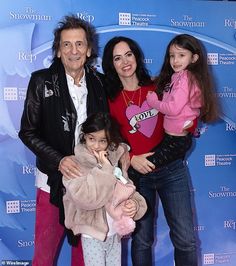 the family is posing for a photo on the red carpet