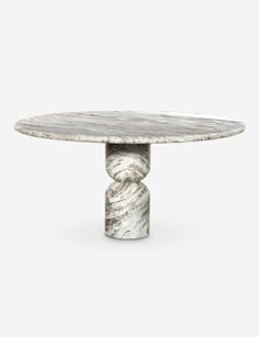 an oval marble table with two pedestals on each side and one column at the end