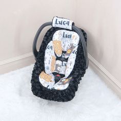 a baby's car seat in the corner of a room with white rugs